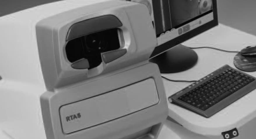 A retinal imaging workstation with its monitor and keyboard.