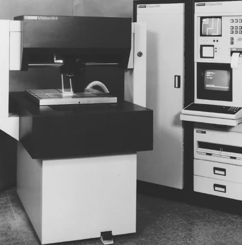 An Optrotech Vision 104 inspection system beside its control console.