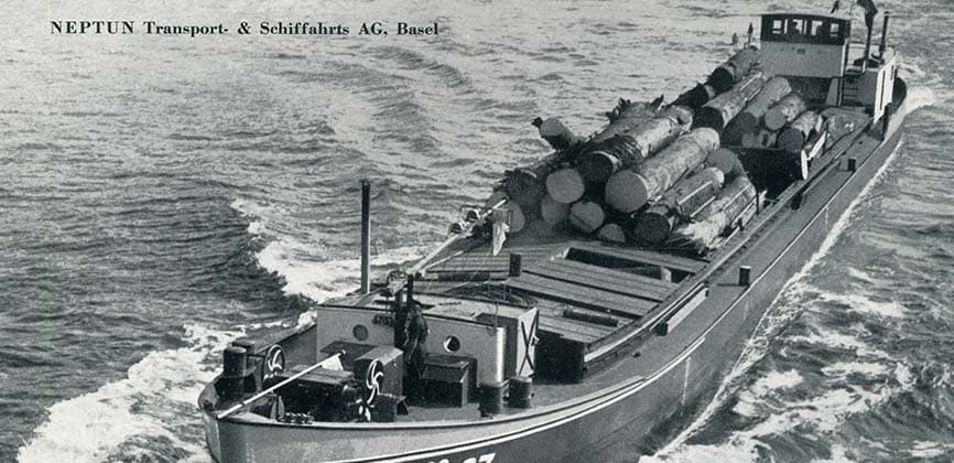 A Neptun Transport- & Schiffahrts AG barge carrying timber on the Rhine.