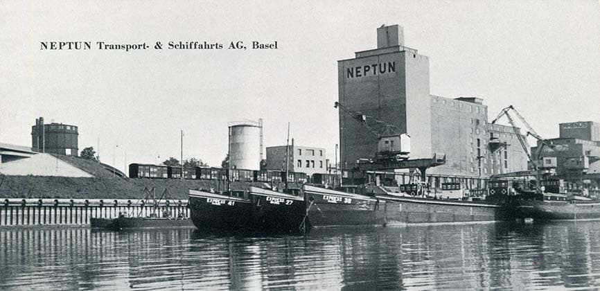 The Neptun grain silo and quay at Basel harbour, barges moored alongside.
